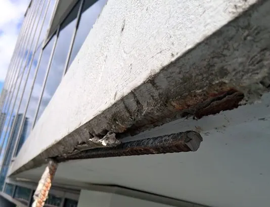 Damaged concrete opened for repair preparation